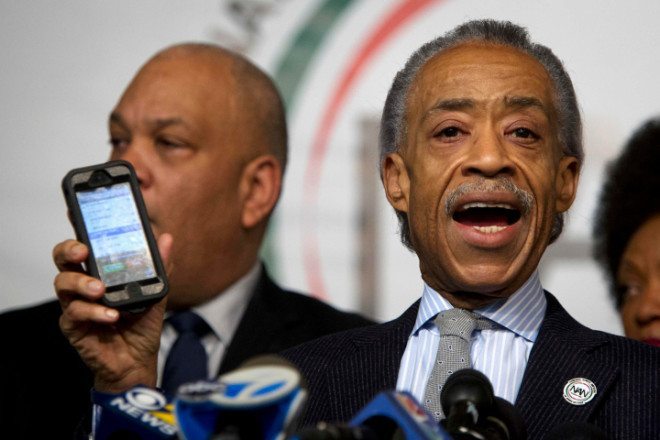 Civil rights activist Reverend Al Sharpton plays a voicemail he says he received following the fatal shooting of two police officers, in Brooklyn